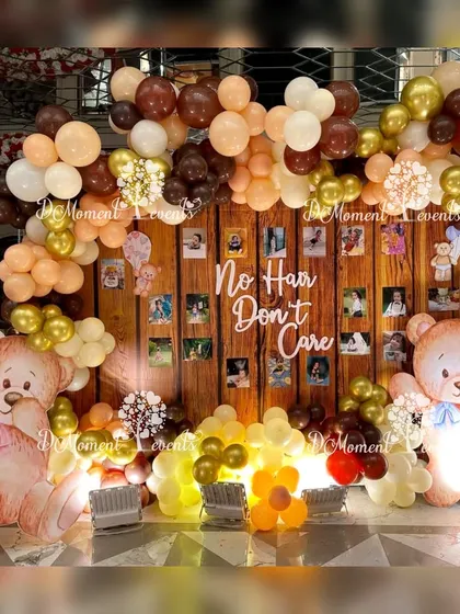 I love adding a touch of humor and personality to traditional ceremonies. This "No Hair Don't Care" photo wall for a Mundan ceremony uses a warm, wood-paneled backdrop, earthy-toned balloons, and adorable teddy bears to create a fun and memorable photo opportunity.