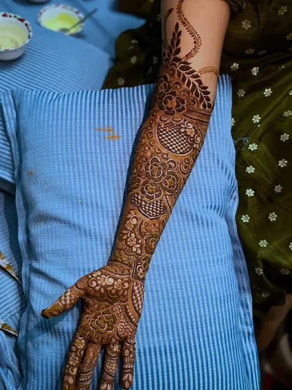 A single arm view of the traditional bridal henna, showing the detailed patterns and the flow of the design.