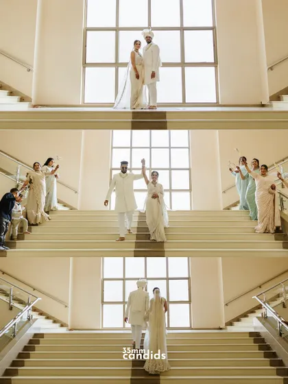 A stunning sequence of the couple's grand exit down a large staircase, surrounded by their loved ones. The symmetry and emotion make this a powerful set of images.