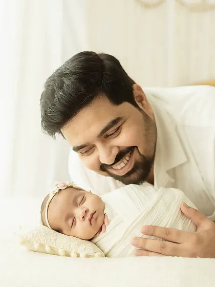A father's love, reflected in his smile. These are the quiet, in-between moments I strive to capture, showing the deep, personal connection with a new baby.