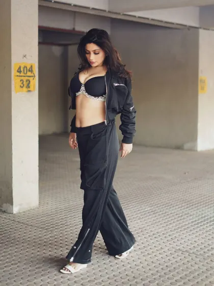 A walking shot that adds a sense of movement and narrative to the series. It feels like a candid moment captured on the streets of Mumbai.
