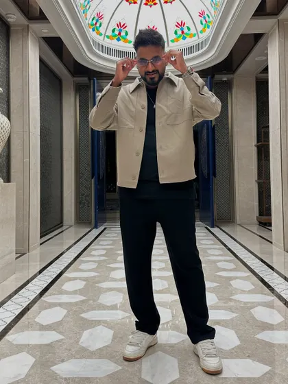 Adjusting my glasses in a grand hotel hallway.