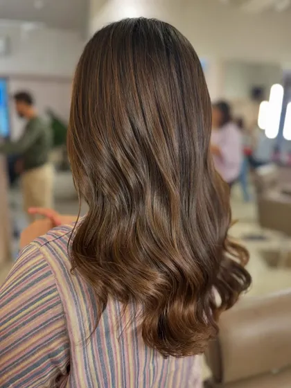 A side view showing how the subtle brown highlights frame the hair. This is a great low-maintenance color option. (No filter)