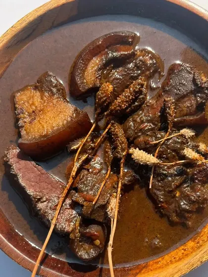 The rich, dark broth of our Smoked Pork with Anishi curry. It's a nutritious and flavorful dish that represents the resilience and resourcefulness of the Ao Naga tribe.