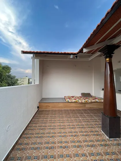 Another view of the traditional terrace, showing the built-in seating and patterned tile flooring. It's a perfect blend of vernacular architectural elements and modern comfort.