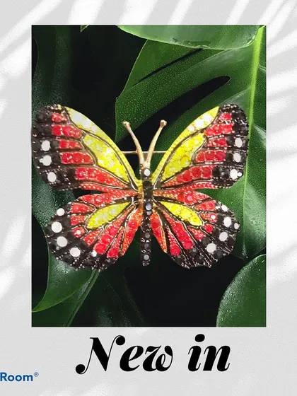 A new addition to our collection, this butterfly brooch features a stunning red and yellow enamel design dotted with crystals. The natural setting highlights its vibrant, lifelike colors.