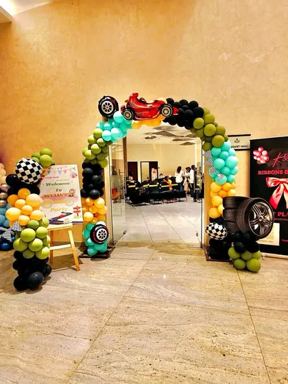 An identical shot of the car-themed entrance arch for Avyaan's party.