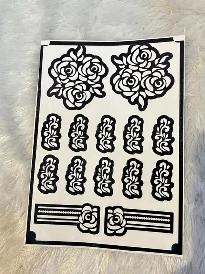 A rose-themed stencil set. It includes two larger rose clusters and multiple smaller elements for fingers or for creating a scattered pattern. It also has a beautiful rose-themed wristband stencil.