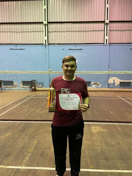 One of our top performers holding his certificate and medal after a strong showing in the Mumbai University Thane zone tournament.