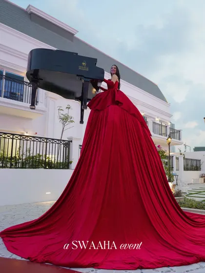 I believe entertainment should be a spectacle. This performer, playing a grand piano from within a flowing crimson gown, is an example of the unique, show-stopping experiences I curate to make your celebration truly extraordinary and leave guests in awe.