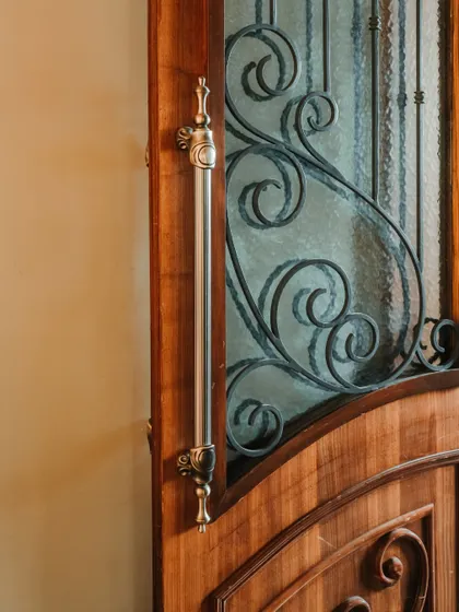 A close-up of the custom door handle and intricate metalwork on the entrance door. This level of detail demonstrates my commitment to craftsmanship and creating a complete sensory experience.