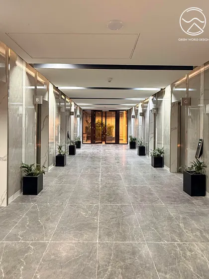The elevator lobby at The Executive Centre, Hyderabad. Even transitional spaces are treated as opportunities for design intervention, using minimalist planters to create a sense of calm and order.