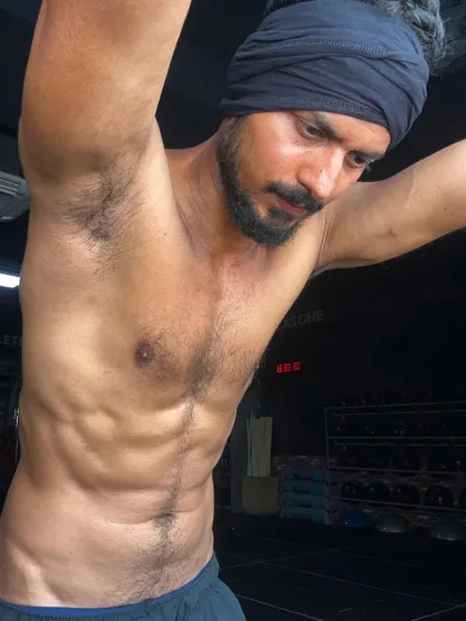 A stretched pose that highlights the definition in my abs and obliques. This is the result of dedicated core training.