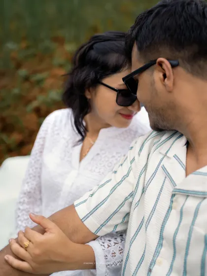 A close-up of the couple sharing a tender moment, their sunglasses adding a cool, modern vibe to this romantic pre-wedding photo.