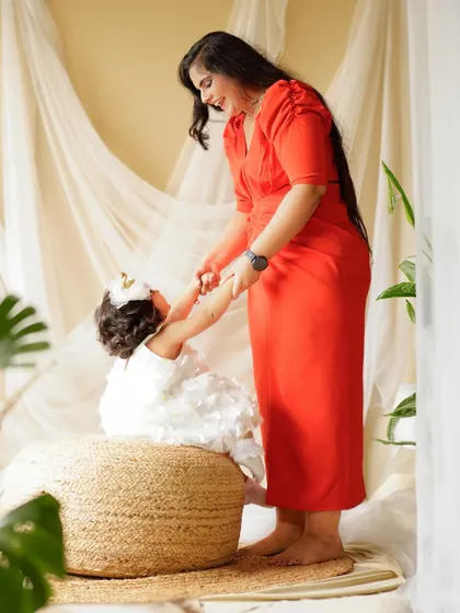 A mother gently holds her daughter's hands. These quiet, connected moments are just as important as the big smiles in telling your family's story.