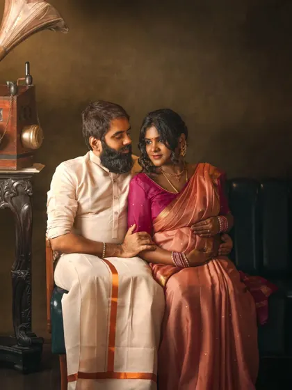 This portrait captures the essence of my work: a timeless, painterly moment shared between two people awaiting their new arrival. We used a vintage gramophone and classic furniture in the studio to create this unique, rich composition, blending their connection with a touch of old-world artistry.