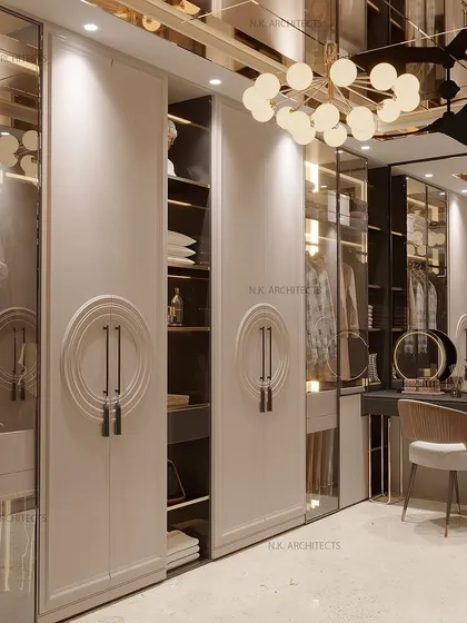This view shows the sliding wardrobe doors, which reveal well-organized internal storage. The mirrored ceiling and modern chandelier make the space feel bright and expansive.