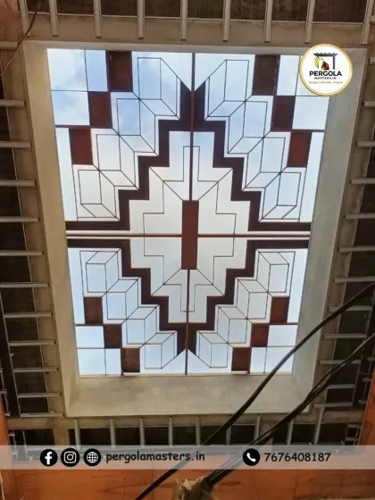 This stained-glass effect skylight was crafted using colored and frosted panels set in a geometric pattern. It provides diffused, softened light and adds a touch of classic elegance to the interior architecture.