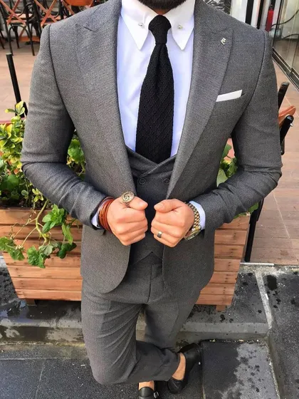 A sharp grey three-piece suit. This is a versatile and essential piece for any man's formal wardrobe, and I ensure the fit is impeccable.