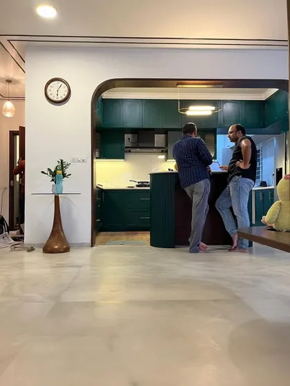 Client, chai aur charcha. A candid moment in a newly designed space, where the kitchen bar becomes the perfect spot for discussion.