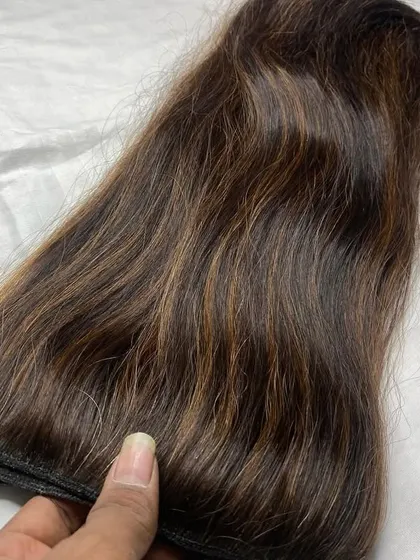 Feeling the soft texture of a 150-gram clip-on set. I only use 100% human hair, so it looks and feels completely real.