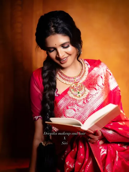 An artistic shot of a bride in a stunning red saree, showing how my makeup and hair styling works for photoshoots as well.
