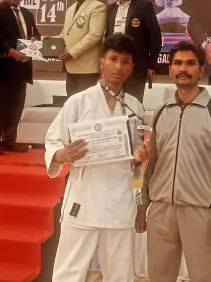 Another proud moment for a student on the podium at the state-level selections, holding his certificate and trophy.