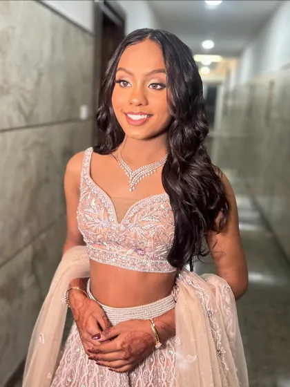 A simple yet elegant open hairstyle with soft waves for a reception. This look is all about enhancing the hair's natural beauty.