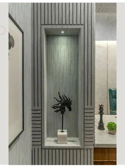 A custom niche built into the grooved wall, creating a perfect spot to display art and artifacts within the office.