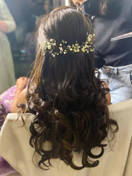 A classic half-updo with baby's breath, a versatile style that works for many different wedding events.