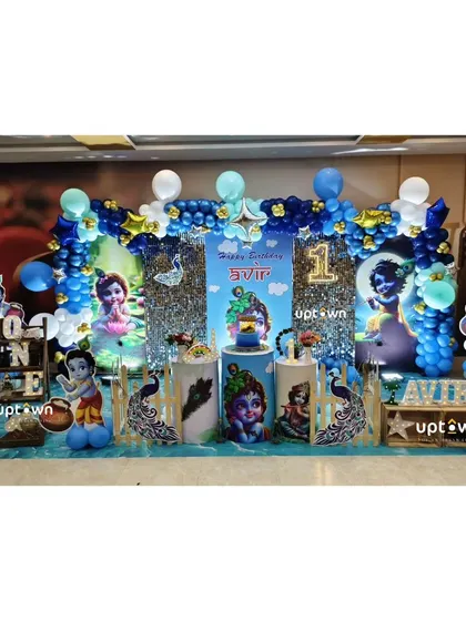 A unique Krishna themed first birthday party with traditional motifs and character cutouts.