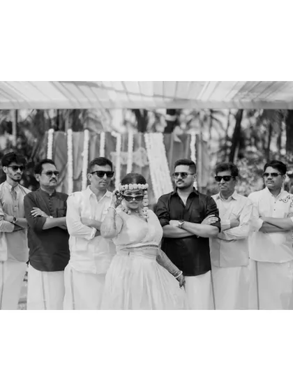 A fun, stylish black and white shot of the bride and her 'bride squad' posing with sunglasses during the Haldi event.