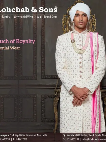 For a touch of royalty, we've styled this classic ivory sherwani with a vibrant pink stole. This small addition of color adds a celebratory feel to the traditional groom's attire, perfect for a day wedding.