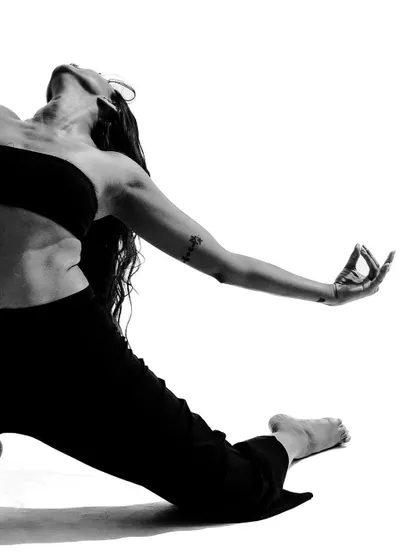 A close-up on a pose showing the detail of the hand gesture and the arch of the back.