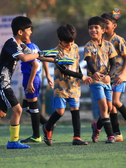 A moment of sportsmanship and camaraderie between teammates after a successful play.