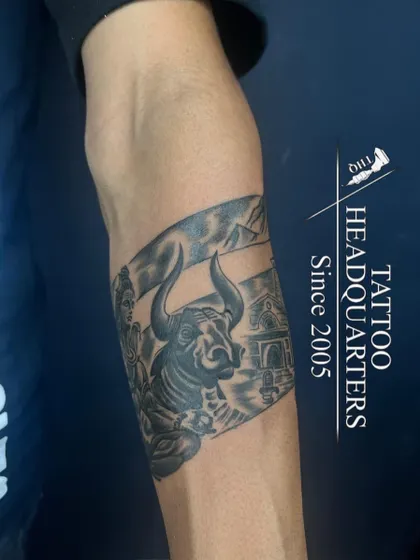 This armband tattoo features a detailed depiction of Lord Shiva with Nandi at the Kedarnath temple, a powerful piece for devotees.