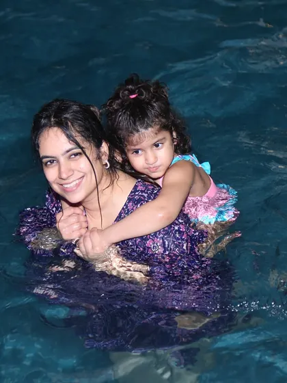 The pool is for everyone. Here's a lovely moment of a mother and daughter enjoying a swim.