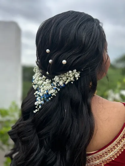 A side view of the floral cascade hairstyle, showing how the flowers are woven into the hair.