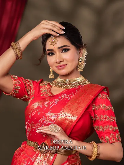 The bride in a playful, traditional pose. This shot captures her personality and the beauty of the complete look, from makeup to attire.