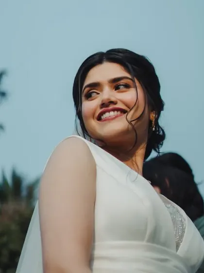 A gorgeous upward shot capturing her happy expression. The soft tendrils framing her face add a touch of romanticism to her classic updo.