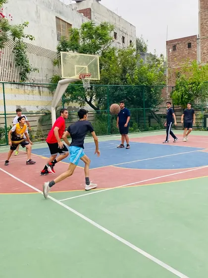 A player dribbles up the court, looking for an open teammate to start the offense.