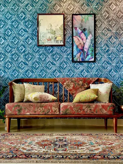 The Sabyasachi sofa as the centerpiece of a room, complemented by a traditional rug and modern wall art, creating an eclectic and stylish look.