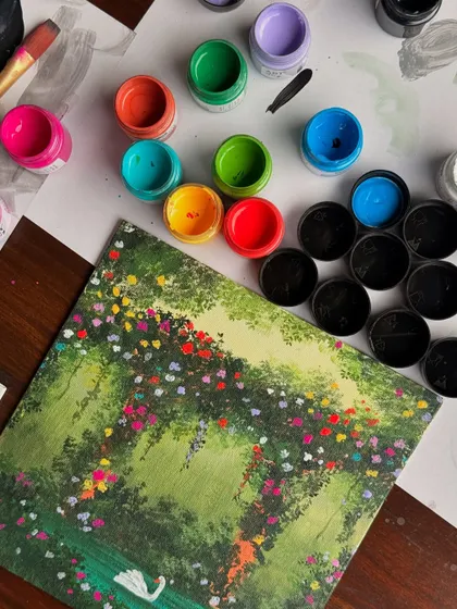 The swan painting next to some of the acrylic paint pots I used. It shows just how many colors went into creating this vibrant garden scene.