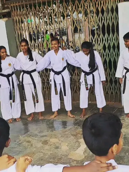 The bond between our senior students is strong. Here, our black belts stand together, supporting the juniors during a Kyu Grading at the Malleshwaram dojo.
