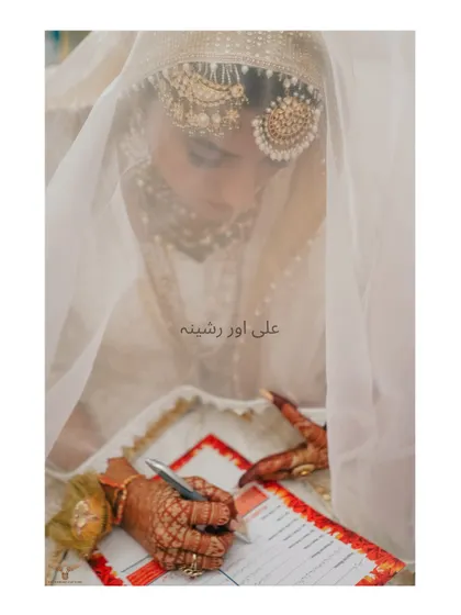 The signing of the Nikkah-nama is a pivotal moment. We captured this through the bride's veil, adding a layer of intimacy and significance to this important act.