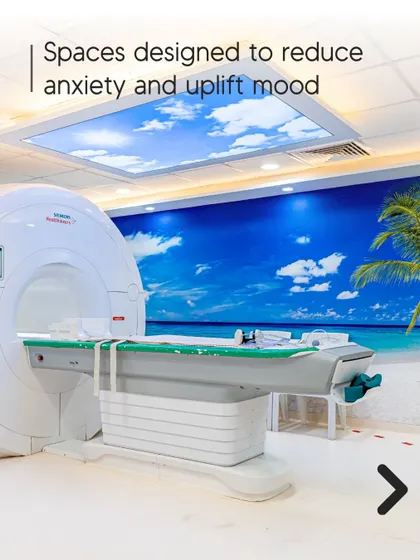 This diagnostic imaging room is designed to reduce anxiety and uplift mood. The wall mural of a serene beach and sky creates a calming, immersive environment, transforming a potentially stressful experience.