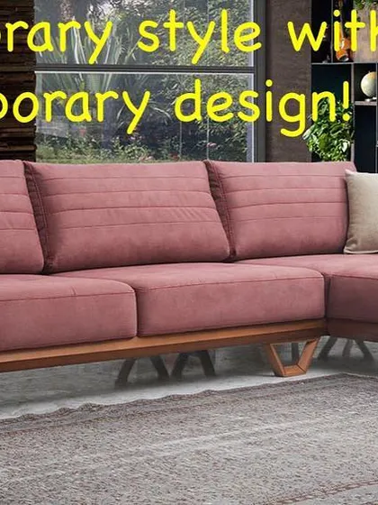 This L-shaped sofa in a muted pink fabric adds a soft touch of color to the room. The design is defined by its clean lines and an exposed wooden frame with unique V-shaped legs, blending mid-century inspiration with contemporary style.