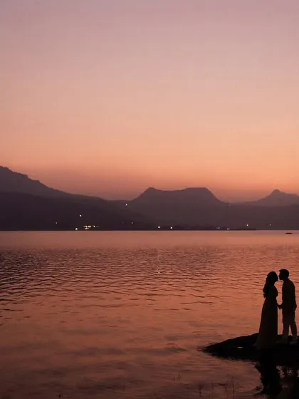 A romantic silhouette of a couple about to kiss against the beautiful twilight sky at Pawna Lake. This is a classic, timeless shot that perfectly captures the romance of the moment.