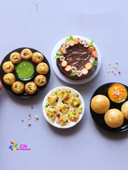 A collection of chaat miniatures, including pani puri, dahi puri, and bhel puri, alongside a tiny chocolate cake.