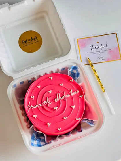 Say it with a cake, no matter how cheeky the message. This vibrant pink bento with the message "pyaar ek dhoka hai" shows how we can have fun with custom text for any occasion.